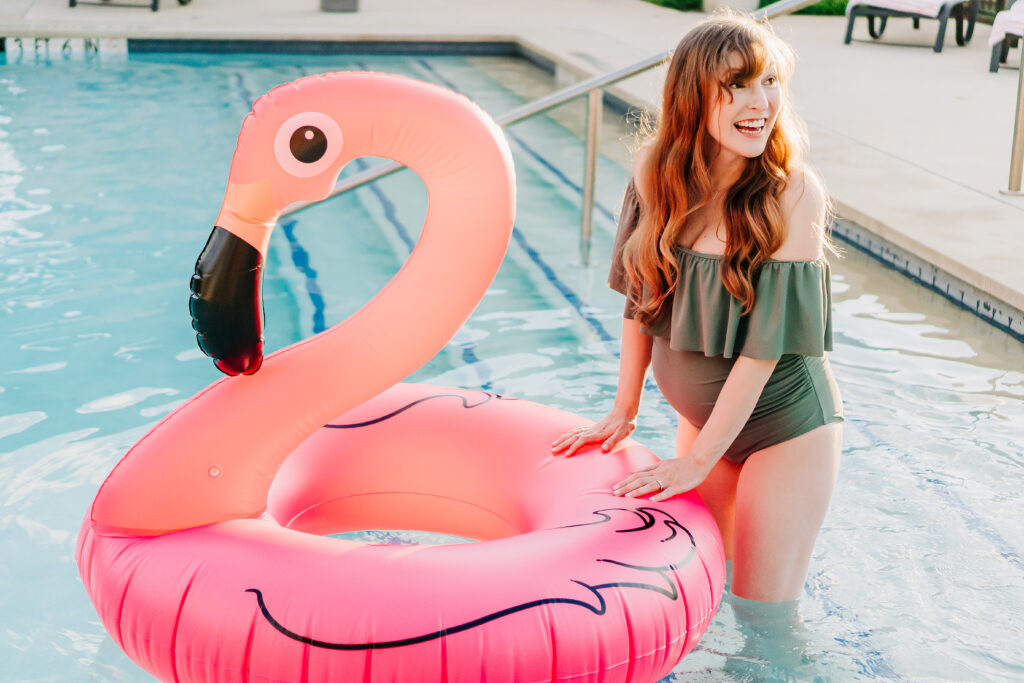 poolside maternity photoshoot in flower mound texas with a blow up flamingo