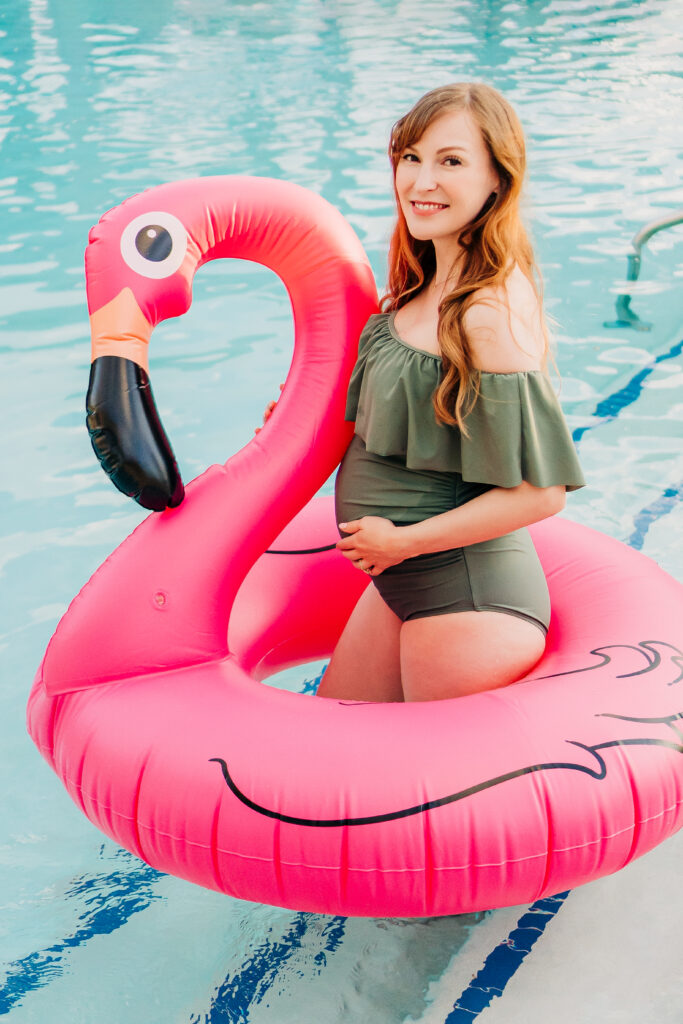 poolside maternity photoshoot in flower mound texas with a blow up flamingo