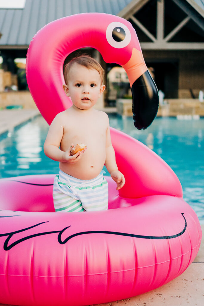 poolside family photoshoot in flower mound texas with a blow up flamingo